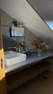 a bathroom with a white sink and a mirror at Casa Cruz Trinta in Trinta +12 photos