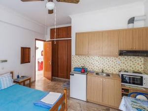 a kitchen with wooden cabinets and a blue counter top at Pension Vienna in Methana