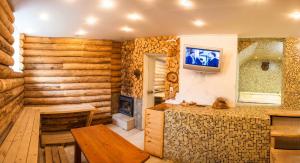 a living room with a fireplace and a wooden wall at Boriki Complex in Pamporovo