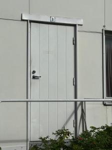 a door on the side of a building at Wooden house studio 1 km from river Turku in Turku