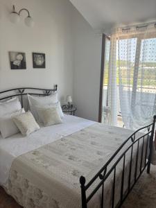 a bedroom with a large bed and a large window at Apartman Gorana with swimming pool in Jelsa +23 photos