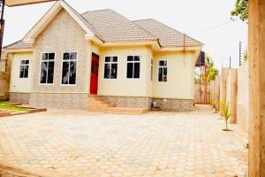 a house with a brick driveway in front of it at Yoyo Celestial Home in Arusha