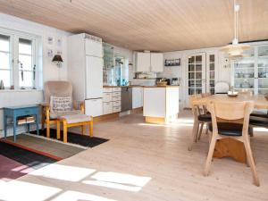 a kitchen and dining room with a table and chairs at 4 star holiday home in Ringkøbing in Ringkøbing +35 photos
