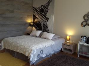 a bedroom with a bed and a picture of the eiffel tower at Carnetin Le Parc, Gite et B&B in Thorigny-sur-Marne