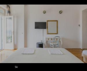 a bedroom with a bed with two towels on it at Riva Brela in Brela