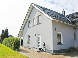 a white house with a black roof at Ferienwohnung Pia in Ostseebad Sellin