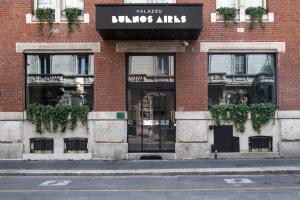 a store front of a brick building with glass doors at Palazzo Buenos Aires in Milan