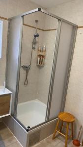 a shower in a bathroom with a stool at Ferienhaus Fuchsbau Hohentauern in Hohentauern