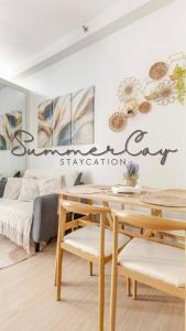 a room with a bed and a sign that reads synergy cut specialization at 2BR FULLY FURNISHED Trees Residences Near SM Fairview with NETFLIX AND KARAOKE in Manila