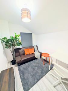 a living room with a couch and a table at Chic En-suite Room with Office Garden and Parking New Renovation in Wainscot
