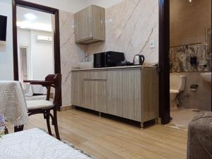 a kitchen with a microwave on top of a counter at New Panorama Inn in Cairo