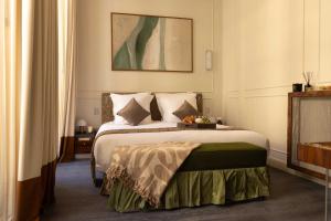 a bedroom with a large bed with at Hotel Palais Bourbon in Paris