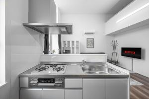 a kitchen with a sink and a stove at Furano Resort Wakaba D in Furano