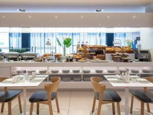 a restaurant with two tables and chairs and a buffet at Eurostars Book Hotel in Munich