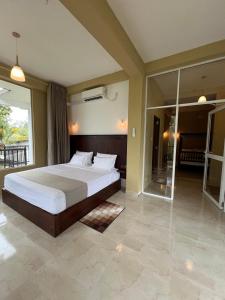 a bedroom with a large bed and a balcony at Ella Family House in Ella +71 photos