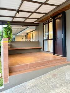 a large empty room with a wooden dance floor at Manna Tatami House KBP Bandung near Wahoo, Whoosh & Parahyangan Golf in Bandung