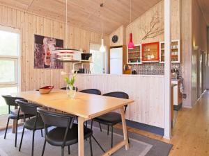 a kitchen and dining room with a wooden table and chairs at Luxury Spa Retreat in Marielyst - By Traum Ferienwohnungen in Marielyst +14 photos