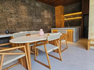 a table and chairs with a vase on top of it at Villa Sucasas, Luxury Pool Villa Nusa Dua, Bali in Nusa Dua