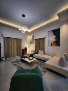 a living room with two couches and a couch at White Swan Mansion in Ketewel