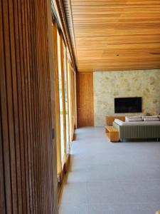 a room with a bed and a tv on a wall at Villa Sucasas, Luxury Pool Villa Nusa Dua, Bali in Nusa Dua +13 photos