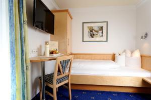 Postel nebo postele na pokoji v ubytování Hotel Garni Valülla