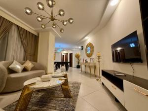 ein Wohnzimmer mit Sofa und Tisch in der Unterkunft DownTown Apartments Gulberg in Lahore