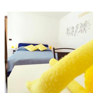 a bedroom with a bed and a yellow stuffed animal at L'angolo segreto di Beltiglio in Beltiglio San Giovanni