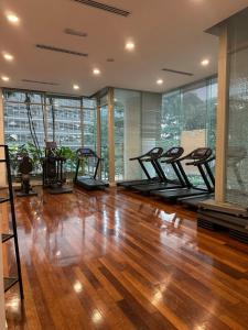 einen Fitnessraum mit einer Reihe von Laufbändern auf einem Hartholzboden in der Unterkunft KLCC Marc Residence by AZ Line in Kuala Lumpur