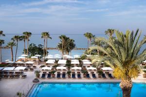a view of a resort with a pool and palm trees at Annabelle in Paphos City