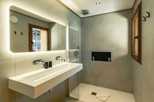 a bathroom with a sink and a mirror at CHALET TEKA LES GETS - Appartement Ubac in Les Gets +29 photos
