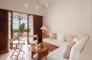 a living room with a white couch and a table at Annabelle in Paphos