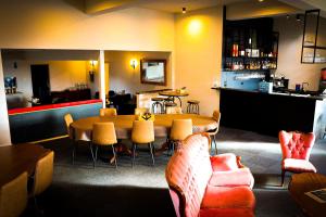 a restaurant with a table and chairs and a bar at Skyline Penthouse Apartments Falls Creek in Falls Creek