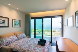 a bedroom with a bed and a view of the ocean at Sintra Hills & Ocean View Luxury House in Colares +52 photos