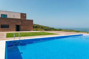 a swimming pool in front of a building at Sintra Hills & Ocean View Luxury House in Colares