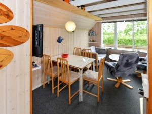 a kitchen and dining room with a table and chairs at 5 person holiday home in Grindsted in Tofterup