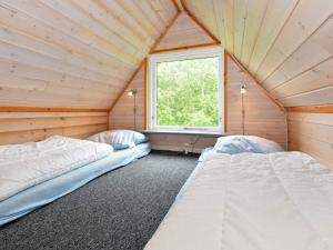 two beds in a room with a window at 5 person holiday home in Grindsted in Tofterup