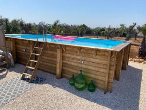 a pool with a ladder next to a swimming pool at Guesthouse il Mare in San Vito dei Normanni