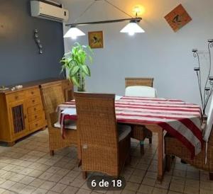 a dining room with a table with a red and white striped table cloth at Villa Soazara in Koungou