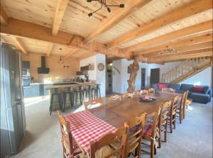 a dining room and kitchen with a table and chairs at Chalet familial 6 chambres 250m2 in Le Dévoluy