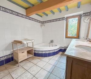 a bathroom with a tub and a sink at Évasion totale, maison de charme en pleine nature in Razengues +37 photos