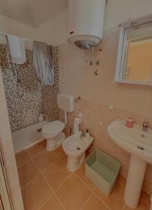 a bathroom with a toilet and a sink and a tub at Casa Vacanze Da Angy & Gio in Grisolia +29 photos