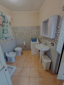 a bathroom with a toilet and a sink at Casa Vacanze Da Angy & Gio in Grisolia +27 photos