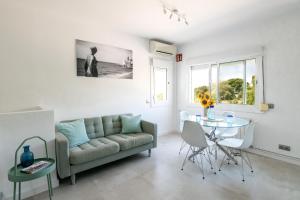 a living room with a couch and a table at Sitges Blue - completamente reformado en 2025 in Sitges