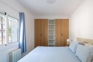 a white bedroom with a bed and a window at Sitges Blue - completamente reformado en 2025 in Sitges +18 photos