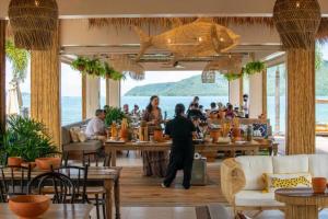 a restaurant with people sitting at tables at Tranquil 2-Bedroom Getaway in Selina Serenity Phuket - Selina #870 in Ban Saiyuan (1)