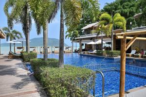 a swimming pool with palm trees and a resort at Tranquil 2-Bedroom Getaway in Selina Serenity Phuket - Selina #870 in Ban Saiyuan (1)