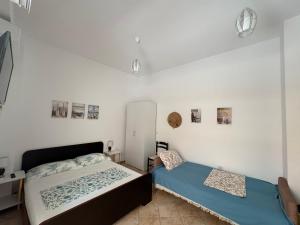 a bedroom with a bed and a cabinet in it at Mira Orikum in Orikum