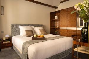 a bedroom with a bed with a tray of fruit on it at Hotel Palais Bourbon in Paris
