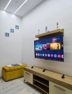 a living room with a large flat screen tv on a wall at La Marine Tabarka in Tabarka