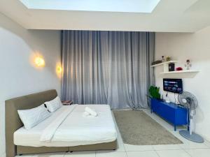 a bedroom with a bed and a window with a fan at Mcity Ampang Residence in KL in Kuala Lumpur +54 photos